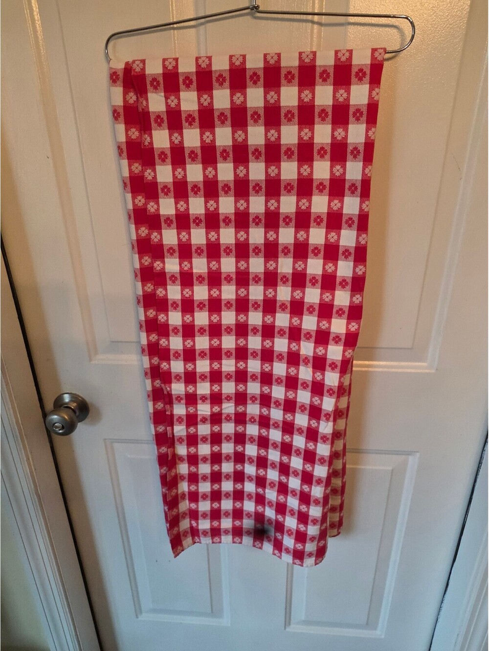 Red and White Checkered Kitchen Towel with Floral Pattern and Small Stain